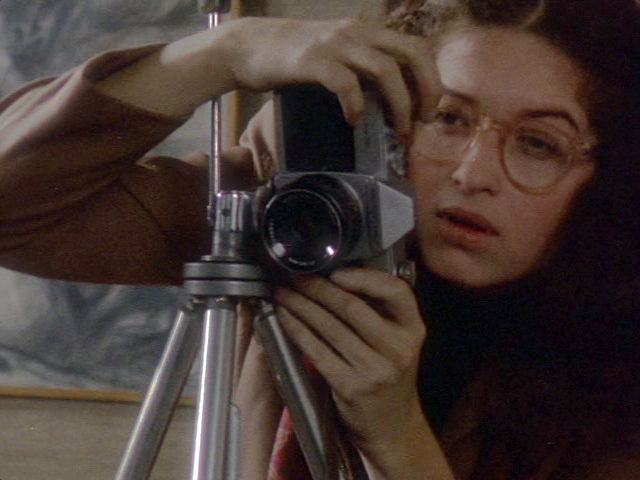 Still of Melanie Mayron in Girlfriends (1978), holding a camera